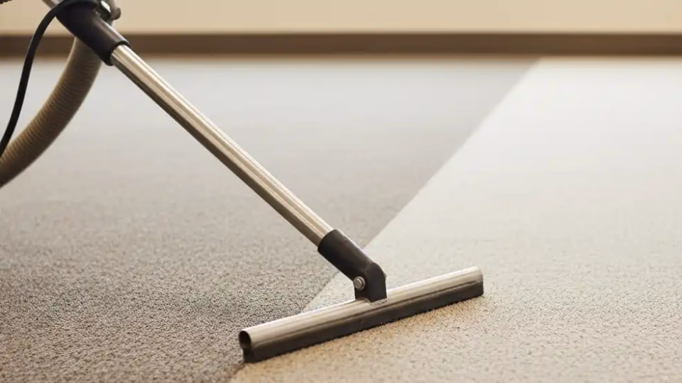 Professional carpet steam cleaning equipment in action on beige carpet